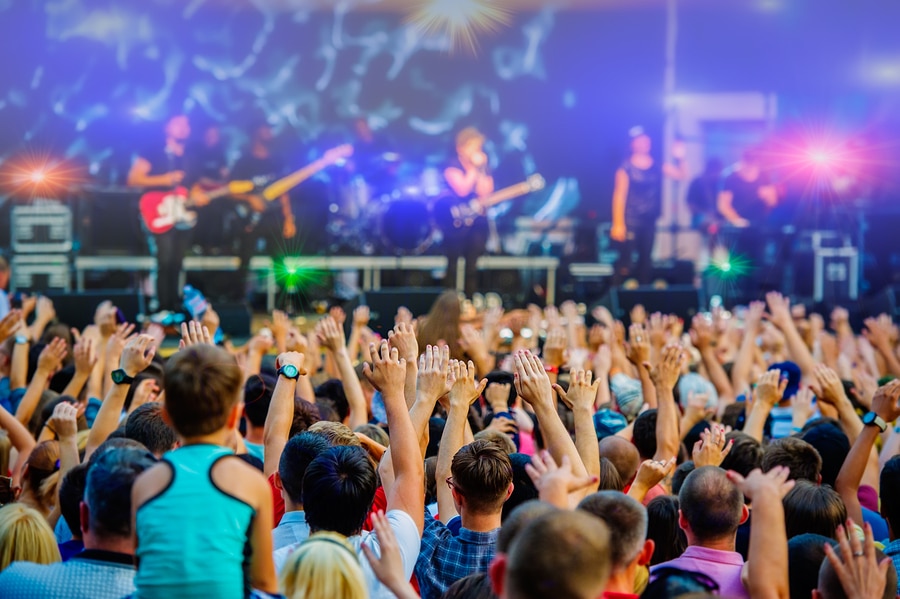 Musical concert rock band in the evening outdoors and fans